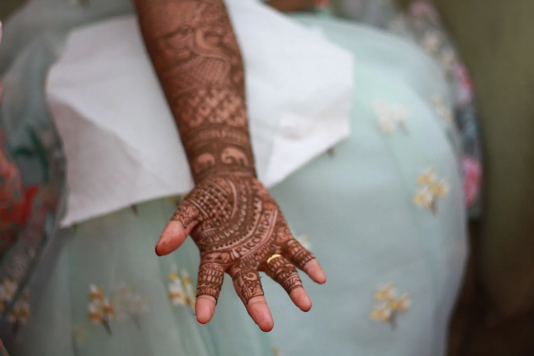 Bridal hands with red outfit and henna